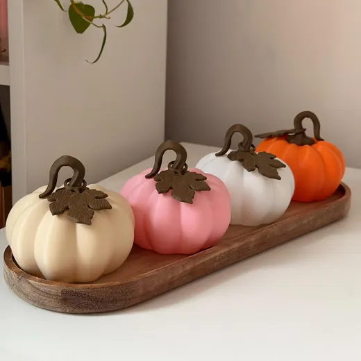Cream, pink, white and orange pumpkins in a row on a wooden tray
